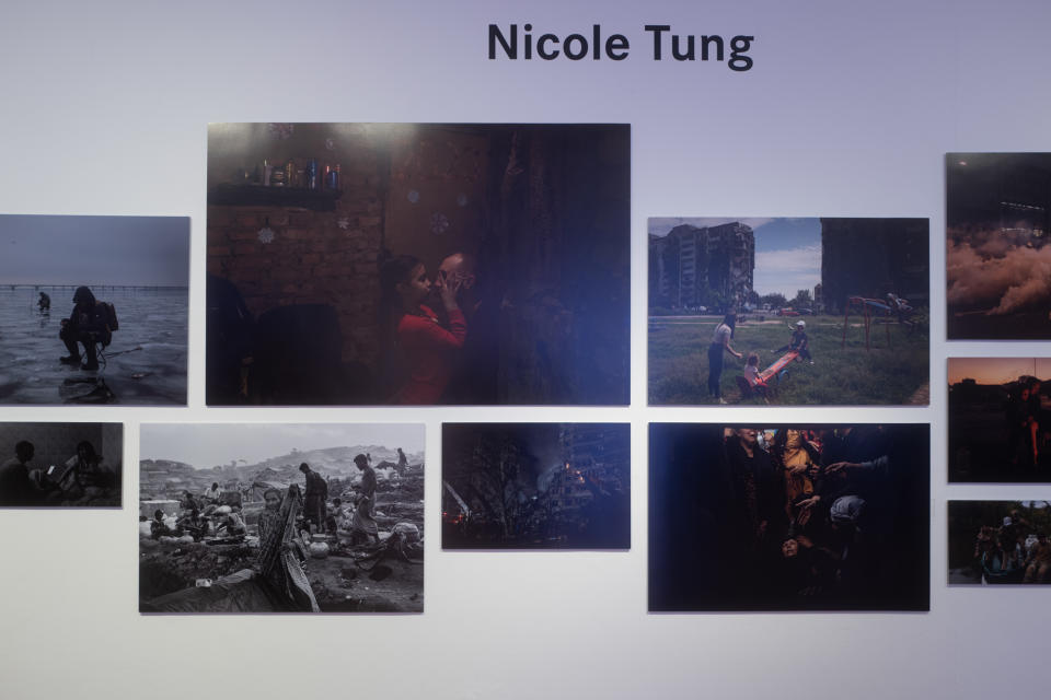 Nicole's works on display in Leica's exhibit Celebration of Photography at Ion Art Gallery, including a picture of a daughter and father in an underground bunker. (Photo: Jay Chan for Yahoo Singapore)