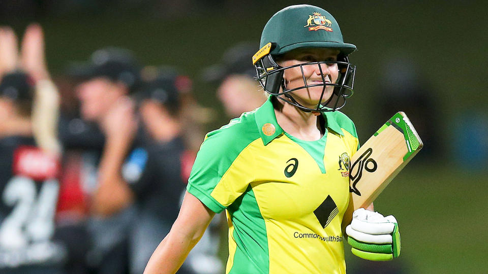 An Australian batter walks off after getting out in a women's T20 match.