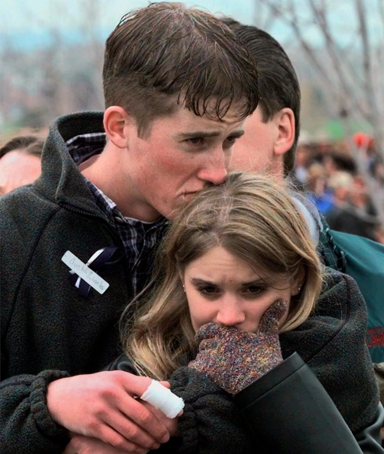 <span>In this 25 April 1999 photo, Austin Eubanks hugs his girlfriend during a memorial service for Columbine high school shooting victims.</span><span>Photograph: Bebeto Matthews/AP</span>