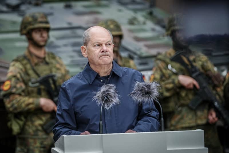 Germany's Chancellor Olaf Scholz makes a joint press statement with Lithuanian President Gitanas Naueda (not pictured) during a visit to the NATO exercise Quadriga 24. Kay Nietfeld/dpa