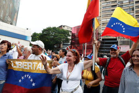 Supporters of Venezuelan opposition leader Juan Guaido, who many nations have recognized as the country's rightful interim ruler, take part in a protest against Venezuelan President Nicolas Maduro's government in Caracas, Venezuela, April 10, 2019. REUTERS/Carlos Garcia Rawlins