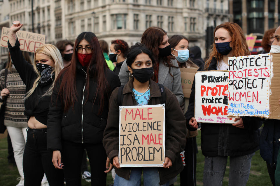 LONDON, ENGLAND - MARCH 15: Members of the public hold up signs during a protest in Parliament Square against the The Police, Crime, Sentencing and Courts Bill and criticising the actions of the police at Saturday night's vigil on March 15, 2021 in London, England. Hundreds of people turned out at Clapham Common on Saturday night to pay tribute to Sarah Everard, a 33-year-old London resident whose kidnapping and death - allegedly at the hands of an off-duty Metropolitan Police officer - prompted a wave of concern over women's safety. The same police force is being criticised for its response to the vigil, where they forcibly arrested several participants for violations of pandemic-era rules on public assembly. (Photo by Dan Kitwood/Getty Images)