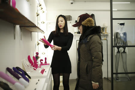 Kwak Eura explains a product to a customer at her sex toy shop in Seoul, South Korea, December 16, 2015. REUTERS/Kim Hong-Ji