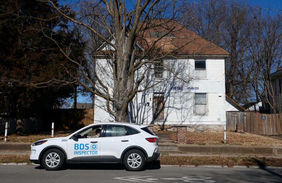 A Springfield Building Development Services inspector at a nuisance property on West Walnut Street on Wednesday, Feb. 9, 2022.