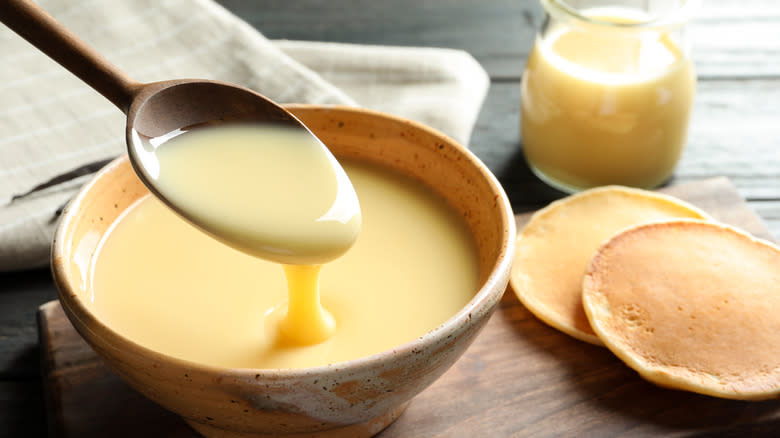 spooning condensed milk from a bowl