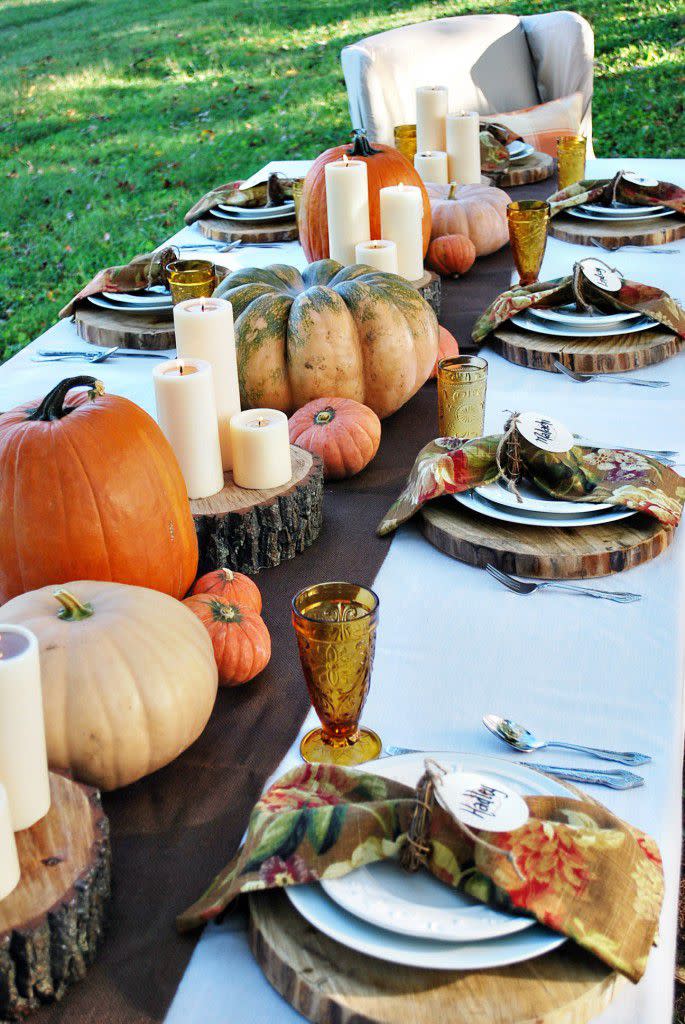 <p>A wide strip of chocolate-brown burlap serves as the runner for this tablescape from <a rel="nofollow noopener" href="http://thewhitebuffalostylingco.com/grateful-harvest/" target="_blank" data-ylk="slk:The White Buffalo Styling Co.;elm:context_link;itc:0;sec:content-canvas" class="link ">The White Buffalo Styling Co.</a> blog. Groupings of pillar candles on wood chips alternate with gourds of various sizes and colors for a simple yet striking look that complements the table's natural setting. </p><p><strong>Get the tutorial at the <a rel="nofollow noopener" href="http://thewhitebuffalostylingco.com/grateful-harvest/" target="_blank" data-ylk="slk:White Buffalo Styling Co;elm:context_link;itc:0;sec:content-canvas" class="link ">White Buffalo Styling Co</a>.</strong></p>