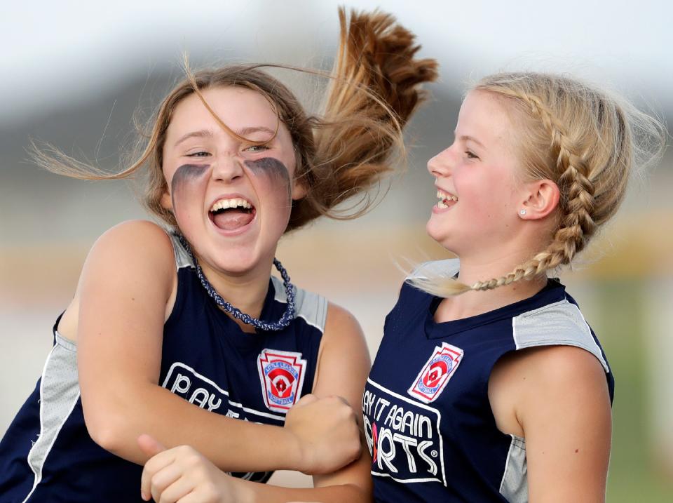 Play It Again Sports’ Cleo Sparkman, left, and Alice Hendrick celebrate their team’s victory over VFW Auxiliary during the Appleton Little League city championship softball game Thursday at Scheels USA Youth Sports Complex in Appleton.