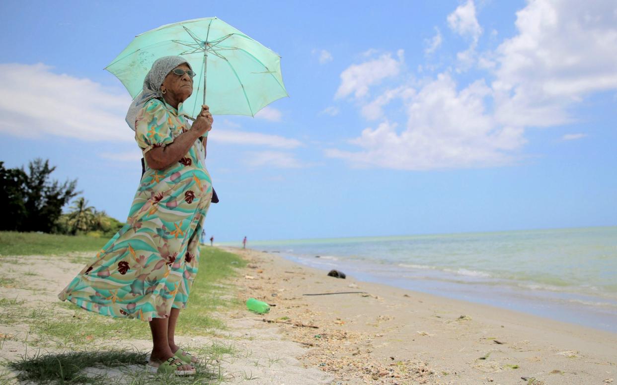A 90-year-old woman who was exiled from the Peros Banhos Atoll of the Chagos Archipelago, stands by the sea on March 1, 2015 in Port Louis, Mauritius - Getty Images Contributor
