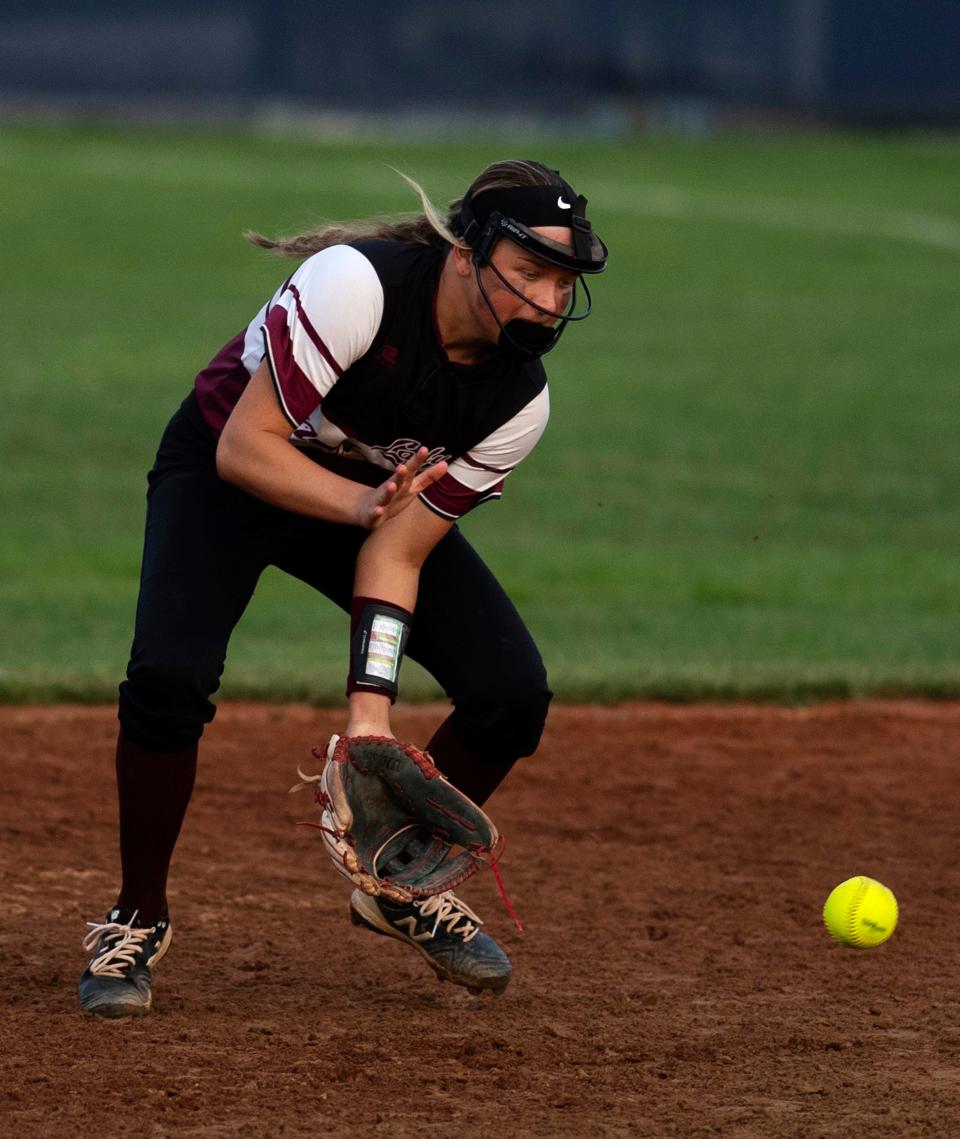 Henderson County's Anna Willett fields a Castle grounder at Castle High School Tuesday evening, April 12, 2022.