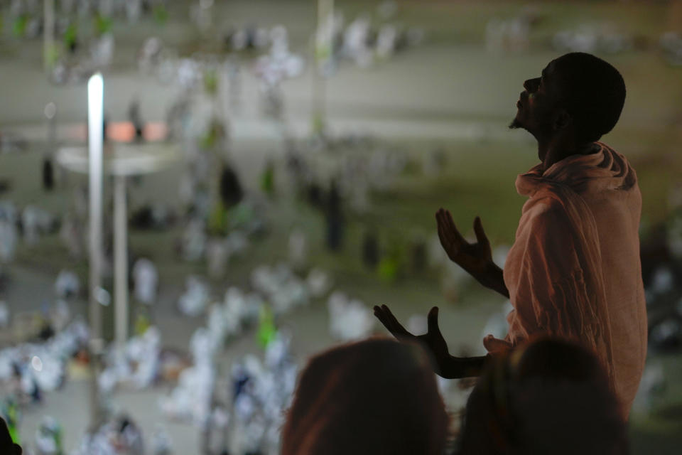 A pilgrim prays on the rocky hill known as the Mountain of Mercy, on the Plain of Arafat, during the annual Hajj pilgrimage, near the holy city of Mecca, Saudi Arabia, Tuesday, June 27, 2023. Around two million pilgrims are converging on Saudi Arabia's holy city of Mecca for the largest Hajj since the coronavirus pandemic severely curtailed access to one of Islam's five pillars. (AP Photo/Amr Nabil)