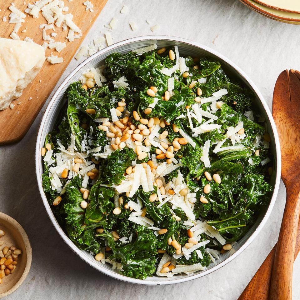 a bowl of kale topped with Parmesan cheese