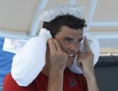 Frank Dancevic of Canada keeps cool with ice packs during a break in play in his men's singles match against Benoit Paire of France at the Australian Open 2014 tennis tournament in Melbourne January 14, 2014. REUTERS/Brandon Malone (AUSTRALIA - Tags: SPORT TENNIS)