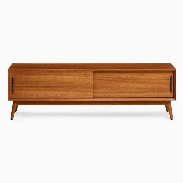 <p><strong>West Elm</strong></p><p>westelm.com</p><p><strong>$849.00</strong></p><p>Forgive us for blasting your timeline with three mid-century modern styles in a row. Something about those tapered, angled-out legs supporting a clean rectangular silhouette just looks so swell. West Elm's rendition of it is also very practical, stretching out at over 60 inches and making room for two spacious cabinets. The smooth sliding door design also uses less space.<br></p>