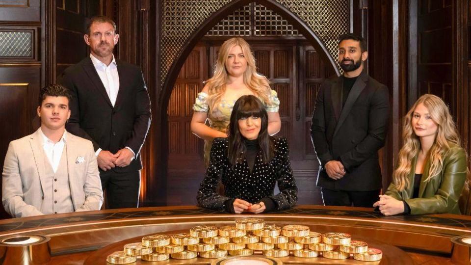 Claudia Winkleman with Traitors contestants (left to right) Harry, Andrew, Evie, Jaz and Mollie