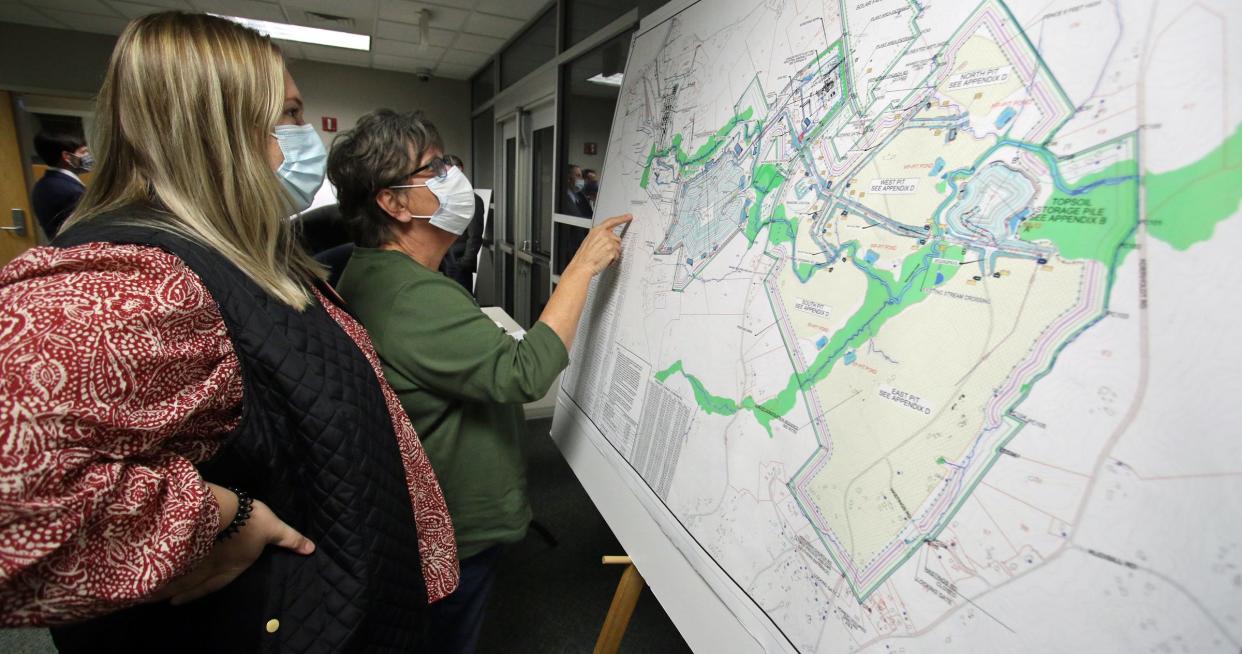 Macie Putnam and her mother, Cathi Putnam, look over one of several maps on display outside the meeting room Monday evening, Nov. 15, 2021, at the Gaston County Courthouse. State environmental officials held a public hearing at the courthouse Monday as part of the process to determine whether to grant a mining permit to Piedmont Lithium.