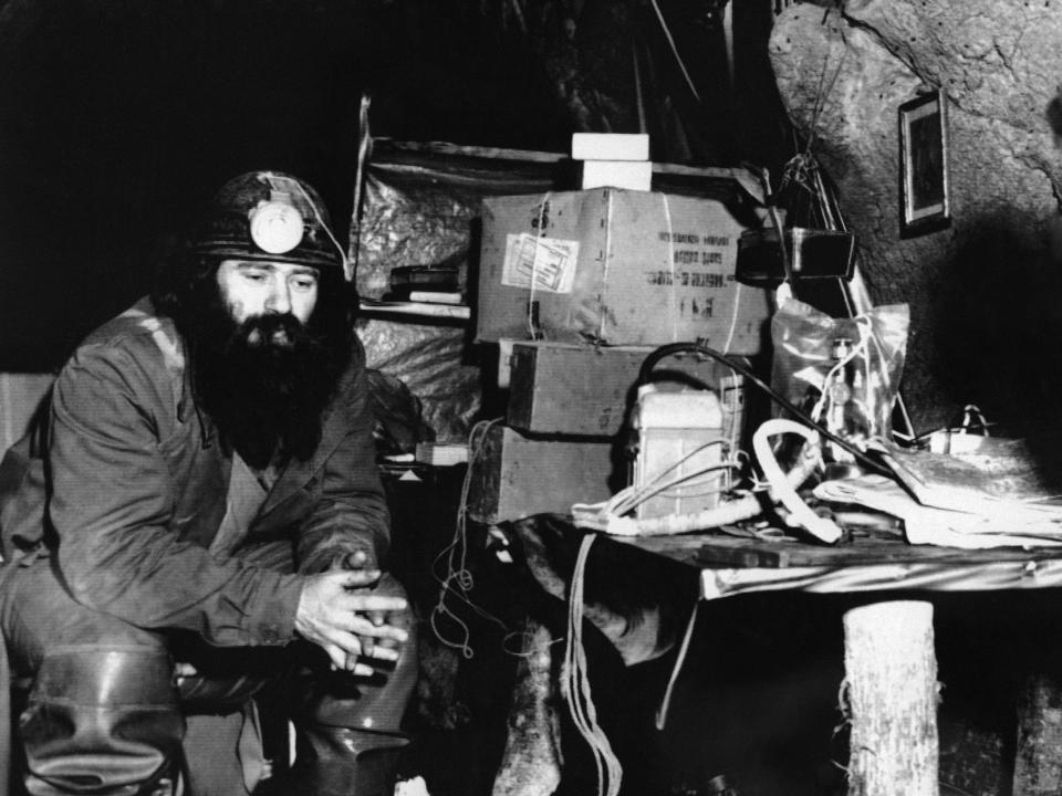 Belgradian speleologist Milutin Veljkovic sits in a Serbian cave in 1970.