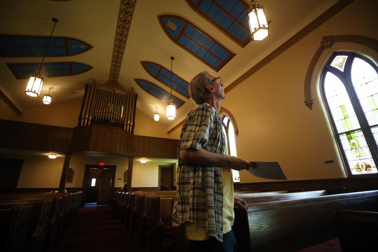 Pastor John Hood of St. James Lutheran Church points out the many original features still present in the church. The church congregation is celebrating its 175th anniversary and the building will be turning 150. The church is to hold an anniversary celebration June 12.