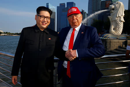 Howard, an Australian-Chinese impersonating North Korean leader Kim Jong-un, and Dennis Alan, impersonating U.S. President Donald Trump, meet at Merlion Park in Singapore June 8, 2018. REUTERS/Edgar Su