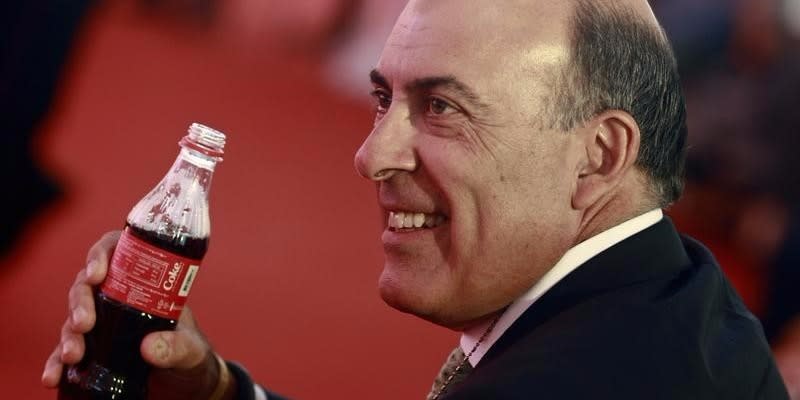 Chief Executive Officer and Chairman of Board of the Coca Cola Company Muhtar Kent holds a Coca-Cola bottle that is made in a Coca-Cola factory in Myanmar, during the factory's opening ceremony, outside of Yangon June 4, 2013.  REUTERS/Soe Zeya Tun 
