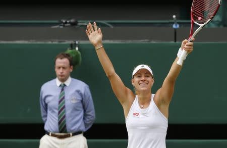 Angelique Kerber of Germany reacts after defeating Maria Sharapova of Russia in their women's singles tennis match at the Wimbledon Tennis Championships, in London July 1, 2014. REUTERS/Suzanne Plunkett