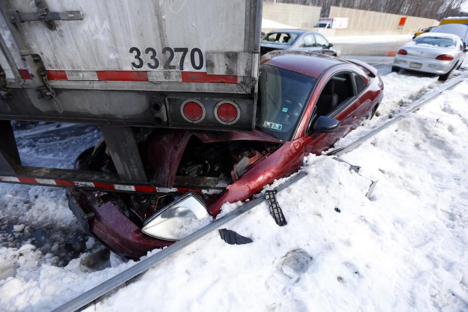 Vehicles are piled up in an accident, Friday, Feb. 14, 2014, in Bensalem, Pa. Traffic accidents involving multiple tractor trailers and dozens of cars have completely blocked one side of the Pennsylvania Turnpike outside Philadelphia and caused some injuries. (AP Photo/Matt Rourke)