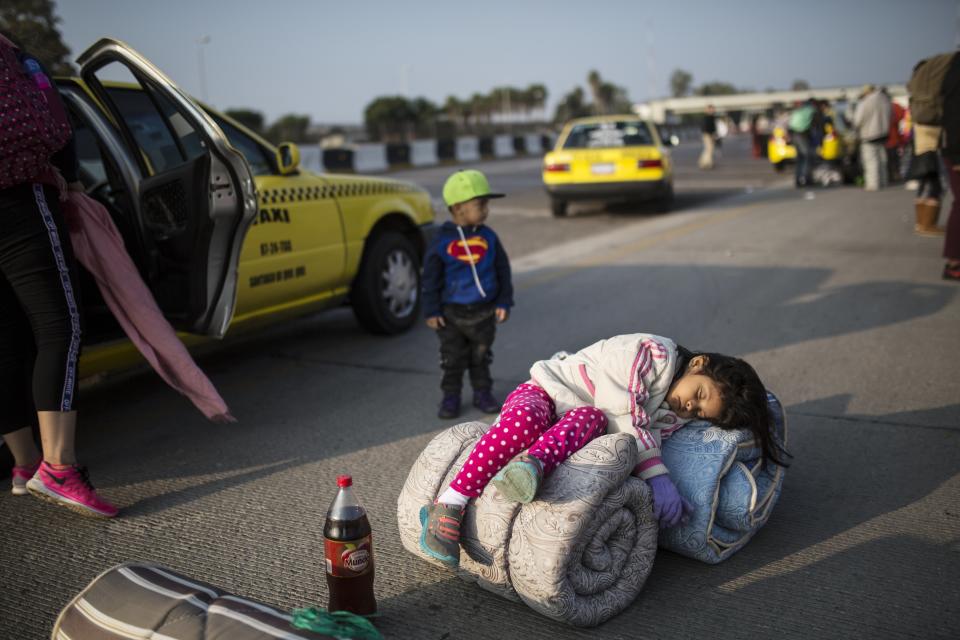 Central American migrant Sofia Hernandez, 5, part of the caravan hoping to reach the U.S. border, sleeps while her family tries to get a ride on a truck, in Celaya, Mexico, Sunday, Nov. 11, 2018. Local Mexican officials were once again Sunday helping thousands of Central American migrants find rides on the next leg of their journey toward the U.S. border. (AP Photo/Rodrigo Abd)