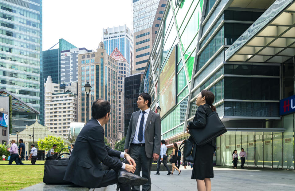 Singapore, 15 January 2019 : office worker and tourist in front of Raffles Place, Central Business District.'