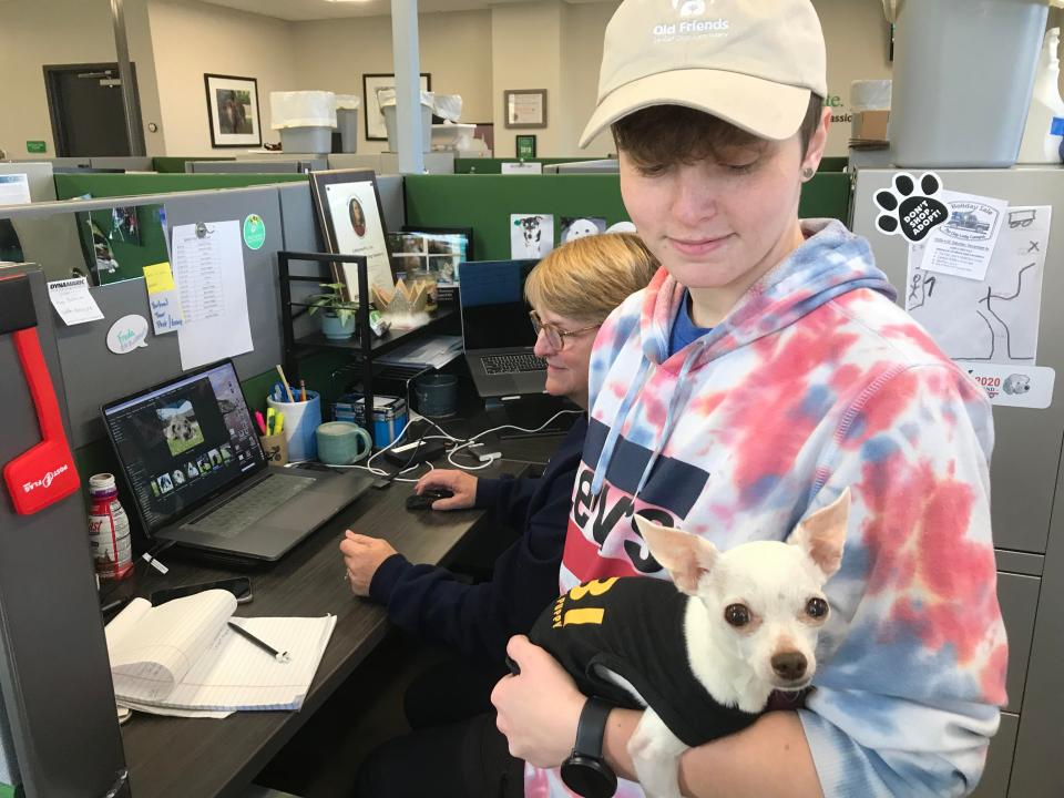 Tyler Dedman (with hat) holds Lieutenant Dan at Old Friends Senior Dog Sanctuary in Mt. Juliet on Nov. 23, 2021. Devi Sanford is sitting.