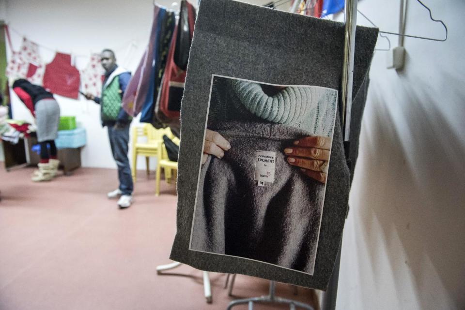 In this Monday, Jan. 30, 2017, a piece of blanket is displayed at a coat workshop charity called Naomi in the northern Greek city of Thessaloniki, which is working long hours to collect and wash discarded blankets and turn them into wearable coats. The blankets are mostly army issue gray with red stitching and are distributed as aid at the sprawling refugee and migrant encampments, and are being recycled into practical coats for the vulnerable refugees who are facing a harsh winter. (AP Photo/Giannis Papanikos)