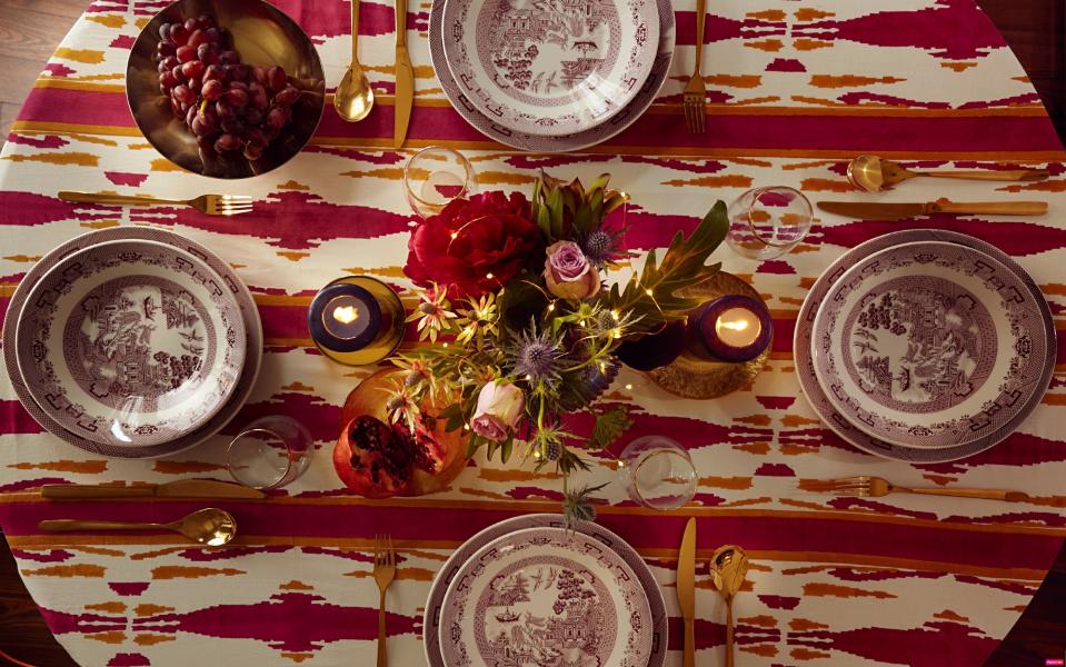 A set dinner table with cutlery laid out in a traditional fashion