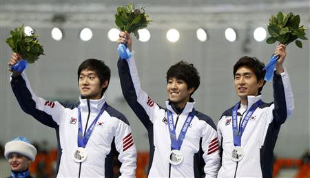 Silver medalists South Korea's skaters celebrate on the podium during the victory ceremony for the men's speed skating team pursuit event at the Adler Arena in the Sochi 2014 Winter Olympic Games February 22, 2014. REUTERS/Issei Kato