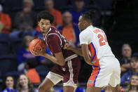 Texas Southern forward John Walker III (24) is defended by Florida guard Phlandrous Fleming Jr. (24) during the first half of an NCAA college basketball game Monday, Dec. 6, 2021, in Gainesville, Fla. (AP Photo/Matt Stamey)