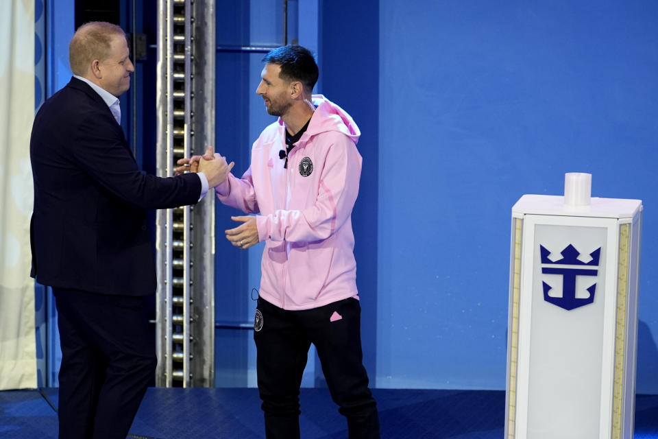 Inter Miami soccer player Lionel Messi, right, shakes hands with Jason Liberty, president and CEO of Royal Caribbean Group, during a naming ceremony for Royal Caribbean International's new cruise ship, Icon of the Seas, Tuesday, Jan. 23, 2024, in Miami. Inter Miami CF has formed a partnership with the cruise line Royal Caribbean International. (AP Photo/Lynne Sladky)