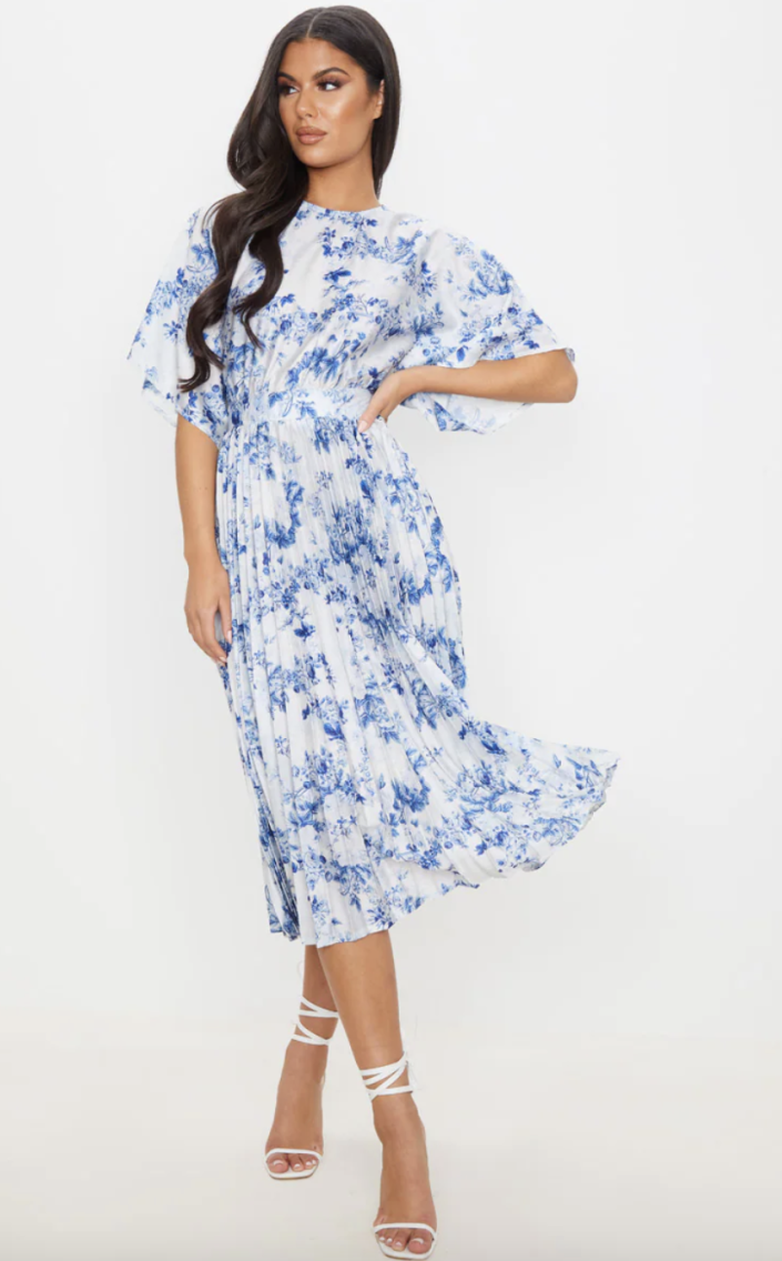 brunette model in white and blue floral Blue Floral Midi Dress (Photo via Pretty Little Thing)