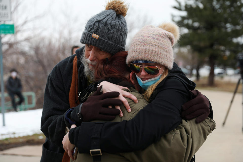 Image: Sarah Moonshadow is comforted by David and Maggie Prowell after Moonshadow was inside King Soopers grocery store during a shooting in Boulder (Alyson McClaran / Reuters)