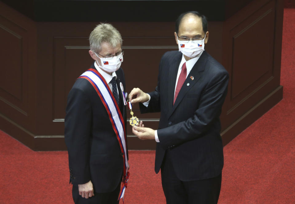The Czech Senate President Milos Vystrcil, left, is decorated with a medal by President of the Legislative Yuan Yu Shyi-kun before Vystrcil delivers a speech at Legislative Yuan in Taipei, Taiwan, Tuesday, Sept. 1. 2020. Vystrcil arrived in Taiwan on Sunday accompanied by Prague Mayor Zdenek Hrib and more than 80 representatives from government, business and academia on a 6-day visit. (AP Photo/Chiang Ying-ying)
