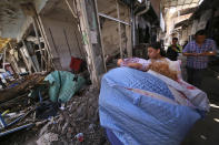 <p>Residents carry belongings they salvages from their damaged houses on parts of the historic district of the mainly Kurdish city of Diyarbakir, southeastern Turkey, May 22, 2016. Turkish authorities have lifted a long-standing curfew from parts of the historic district famed for its ancient city walls listed as a UNESCO World Heritage site, following its security operations to flush out youths and fighters linked to a Kurdish armed movement, that have been underway in parts of the city since December. (Mahmut Bozarslan/AP) </p>