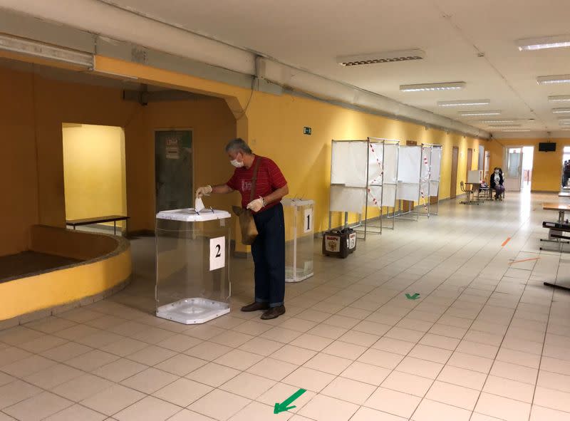 A man casts his ballot at a polling station during a seven-day nationwide vote on constitutional reforms in Reutov