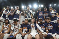 Illinois players pose for a photo after their win over Wisconsin of an NCAA college basketball game in the championship of the Big Ten Conference tournament, Sunday, March 17, 2024, in Minneapolis. (AP Photo/Abbie Parr)