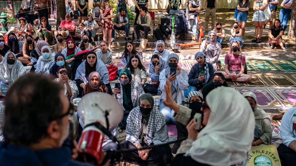 People listen as activists and students protest near an encampment at University Yard, George Washington University on April 28, in Washington, DC. - Kent Nishimura/Getty Images