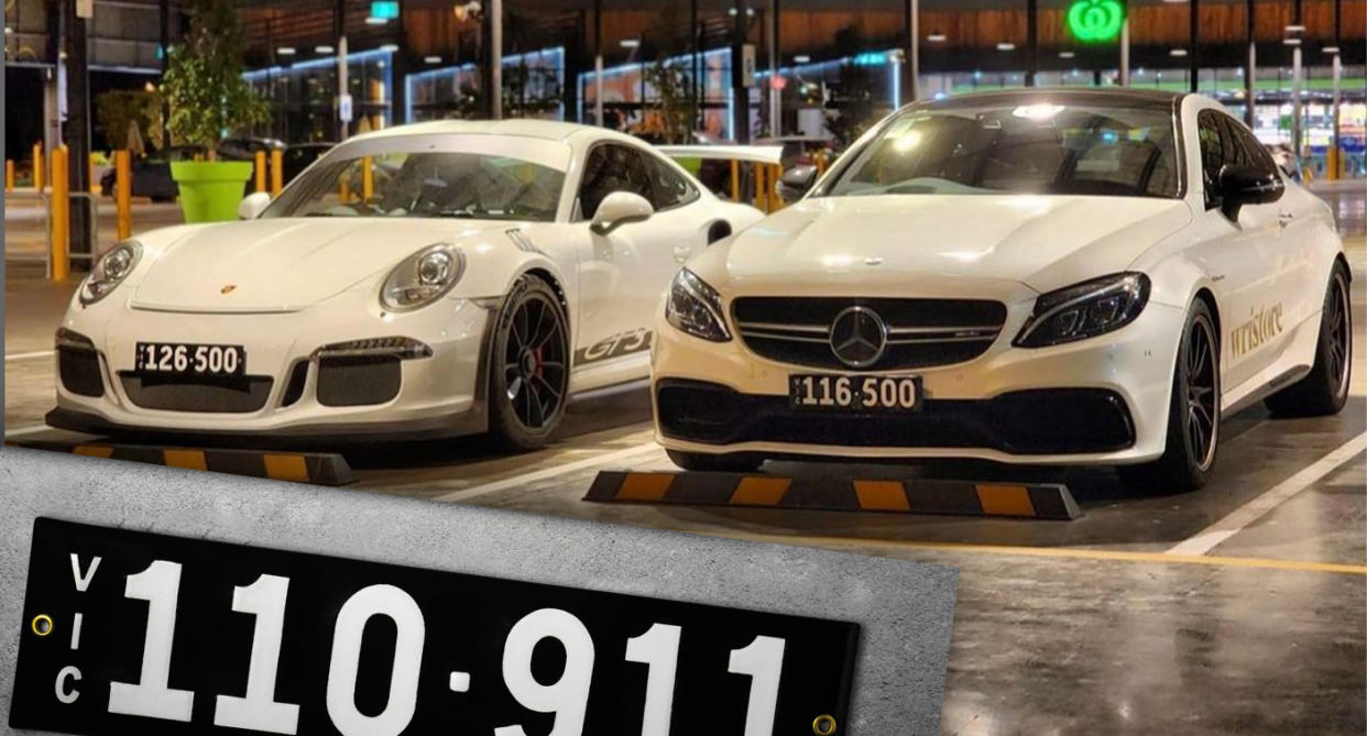 Two parked cars with black and white six-digit Heritage number plates. 