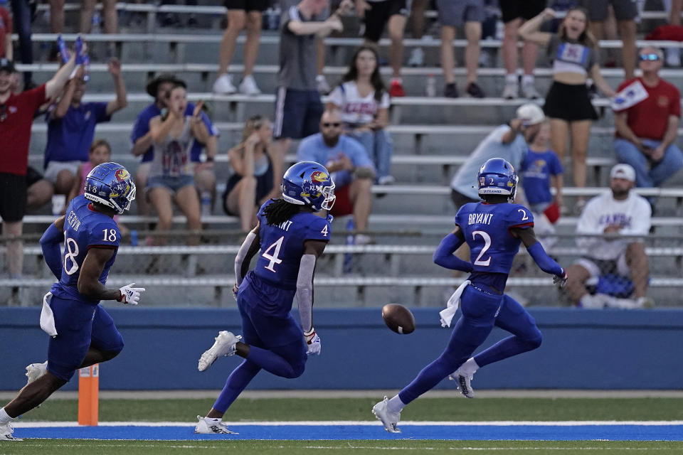 Kansas cornerback Jacobee Bryant (2) is chased by safety Marvin Grant (4) and cornerback Kalon Gervin (18) as he returned a blocked punt to score a touchdown during the first half of an NCAA college football game against Tennessee Tech Friday, Sept. 2, 2022, in Lawrence, Kan. (AP Photo/Charlie Riedel)