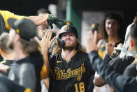 Pittsburgh Pirates' Ben Gamel (18) celebrates with teammates after hitting a home run during the fourth inning of a baseball game against the Cincinnati Reds in Cincinnati, Tuesday, Sept 21, 2021. (AP Photo/Bryan Woolston)