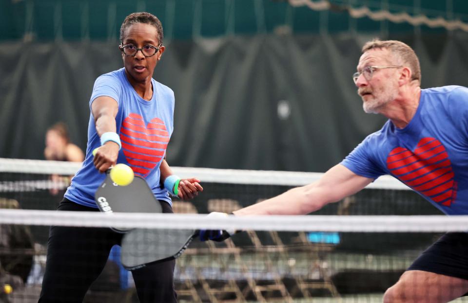 C.D. Woods with partner Ross Zachs return a ball at the net during the Brown Billone Club Pickleball Classic in Easton on Saturday, Feb. 18, 2023.