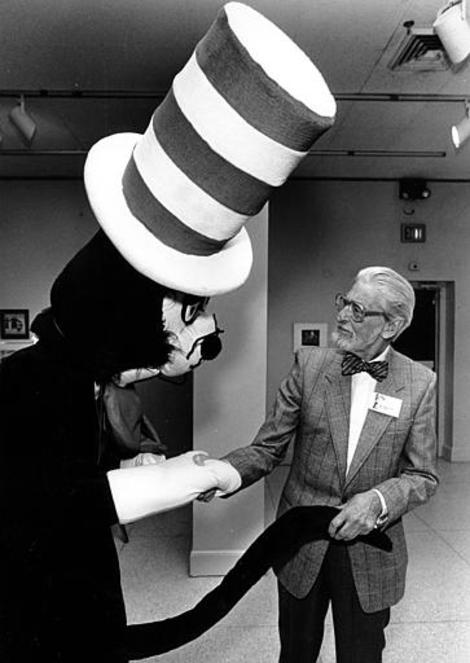 Theodor Seuss Geisel, better-known as Dr. Seuss, shakes hands with Cat in the Hat at the New Orleans Museum of Fine Arts in Louisiana on Feb. 13, 1988. (AP Photo/Burt Steel)