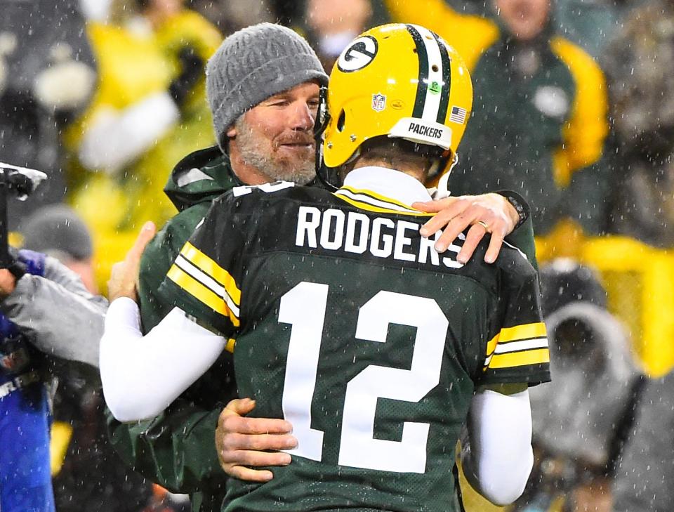 Green Bay Packers former quarterback Brett Favre hugs Green Bay Packers quarterback Aaron Rodgers (12) at halftime for an NFL game against the Chicago Bears on Thanksgiving at Lambeau Field.