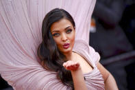 FILE - Aishwarya Rai poses for photographers upon arrival at the premiere of the film 'Armageddon Time' at the 75th international film festival, Cannes, southern France, Thursday, May 19, 2022. Star power has been out in force at the 75th Cannes Film Festival. After a 2021 edition muted by the pandemic, this year's French Riviera spectacular has again seen throngs of onlookers screaming out "Tom!" "Julia!" and "Viola!" The wattage on display on Cannes' red carpet has been brighter this year thanks the presence of stars like Tom Cruise, Julia Roberts, Viola Davis, Anne Hathaway, Idris Elba and others. But as the first half of the French Riviera spectacular has shown, stardom in Cannes is global. Just as much as cameras have focused on Hollywood stars, they've been trained on the likes of India's Aishwarya Rai and South Korea's Lee Jung-jae. (AP Photo/Daniel Cole, File)