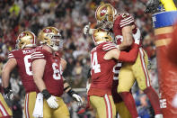 San Francisco 49ers running back Christian McCaffrey, right, celebrates his rushing touchdown with teammates during the second half of an NFL football NFC divisional playoff game against the Green Bay Packers Saturday, Jan. 20, 2024, in Santa Clara, Calif. (AP Photo/Ashley Landis)