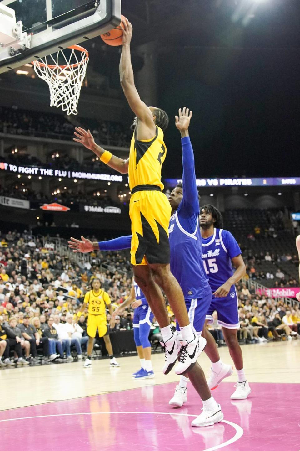 Missouri Tigers guard Tamar Bates, who played at Piper High School in nearby Kansas City, Kan., scores over Seton Hall Pirates guard Al-Amir Dawes during Sunday afternoon’s men’s basketball game at T-Mobile Center in Kansas City.