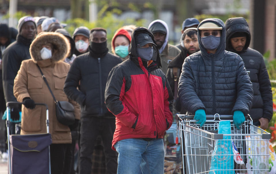 People queue outside a branch of Aldi in south London, a day after the Chancellor unveiled an emergency package aimed at protecting workers' jobs and wages as they face hardship in the fight against the coronavirus pandemic.